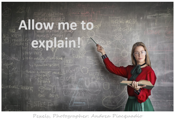 Image of a beautiful young Teacher wearing glasses and pointing to words: Allow me to explain! what a Brand Ambassador does on chalkboard in front of the class