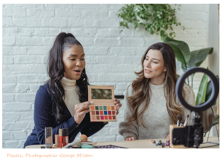 Beauty and makeup brand ambassador showing makeup to influencer