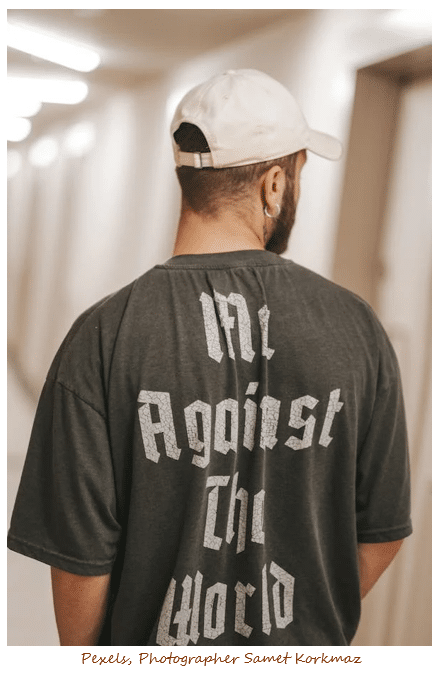 Image of male wearing baseball cap and t-shirt with words "Me Against The World"