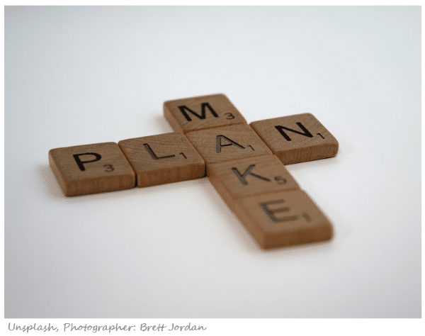 scrabble pieces spelling out the words make plan