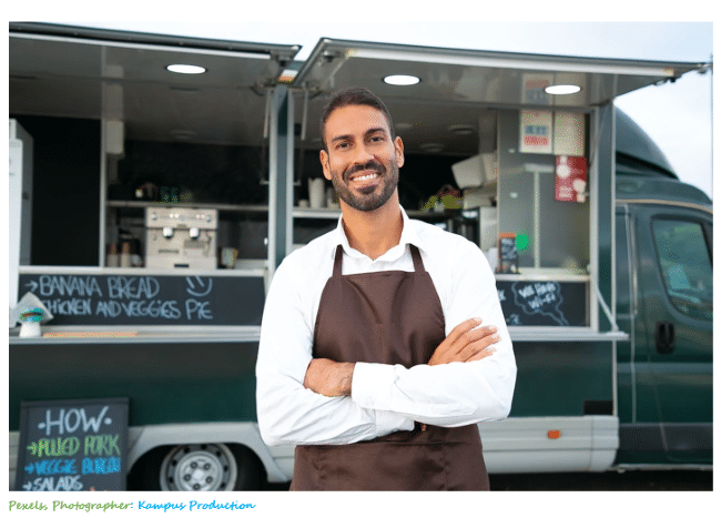 Image of male entrepreneur standing at or in front of his food truck